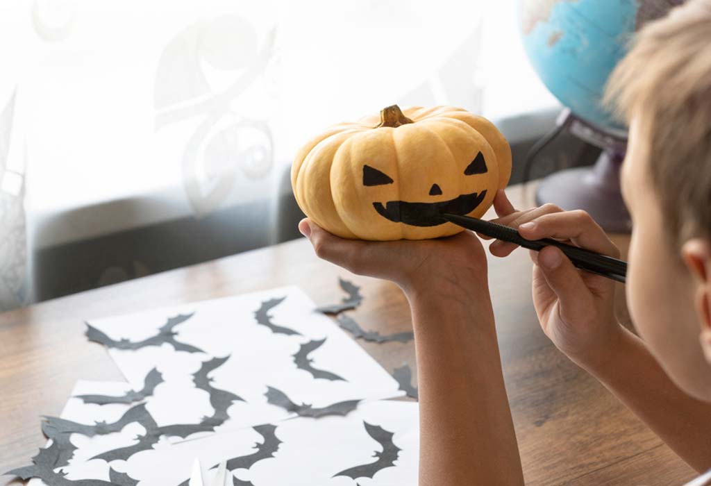 Kid Painting Pumpkin
