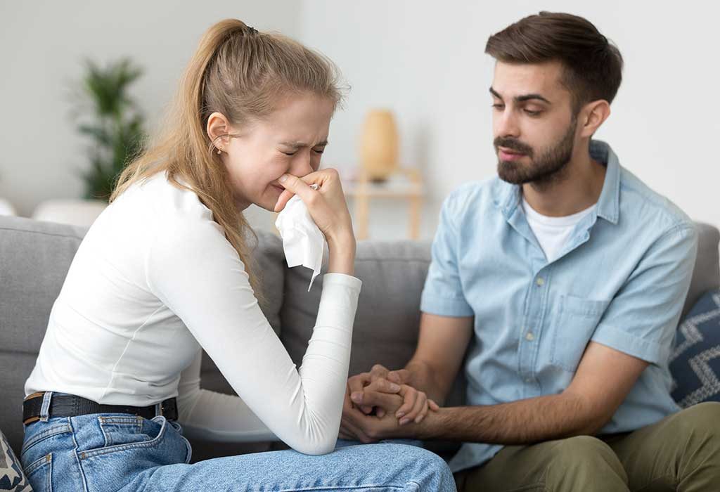 man consoling his friend after a miscarriage